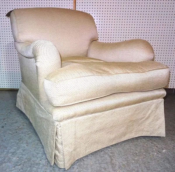 A 20th century low armchair with rollover arms and cream upholstery, 82cm wide  BAY 1