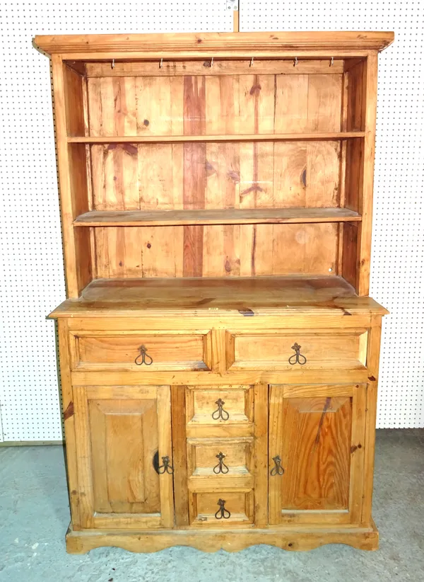 A 20th century hardwood dresser with two tier top, two long drawers and three short drawers flanked by cupboards, 107cm wide x 183cm high.   M6