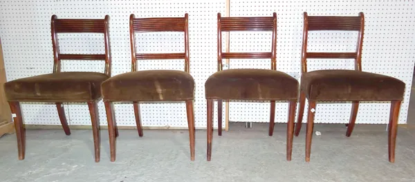 A set of four Regency style mahogany bar back dining chairs on sabre supports, (4).   F10