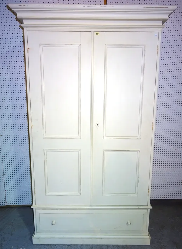 A 20th century cream painted double wardrobe with two panelled doors over single drawer, 121cm wide x 204cm high.   L9