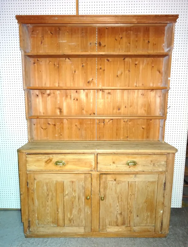 An early 20th century and later pine dresser with enclosed three tier plate rack over a pair of drawers and cupboards, 151cm wide x 216cm high.  M10