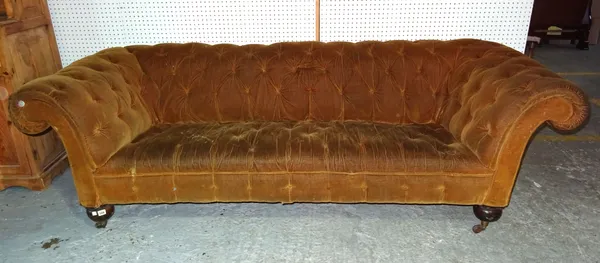 A Victorian button upholstered Chesterfield sofa on turned mahogany supports, 232cm wide.   E8