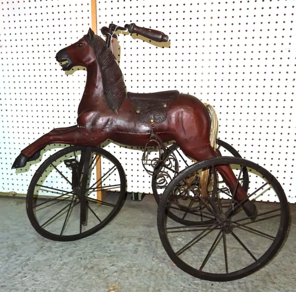 A 20th century child's painted pine tricycle formed as a horse. 72cm high.  D8