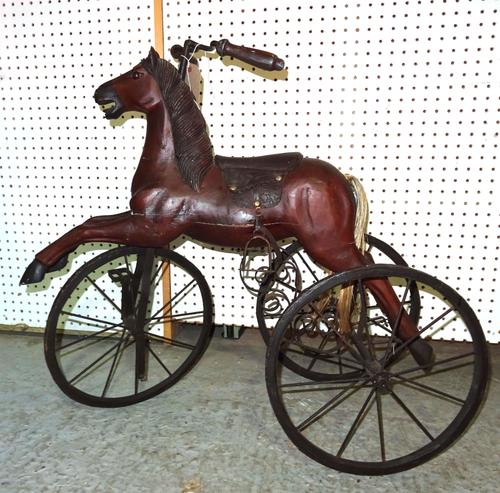 A 20th century child's painted pine tricycle formed as a horse. 72cm high.  D8