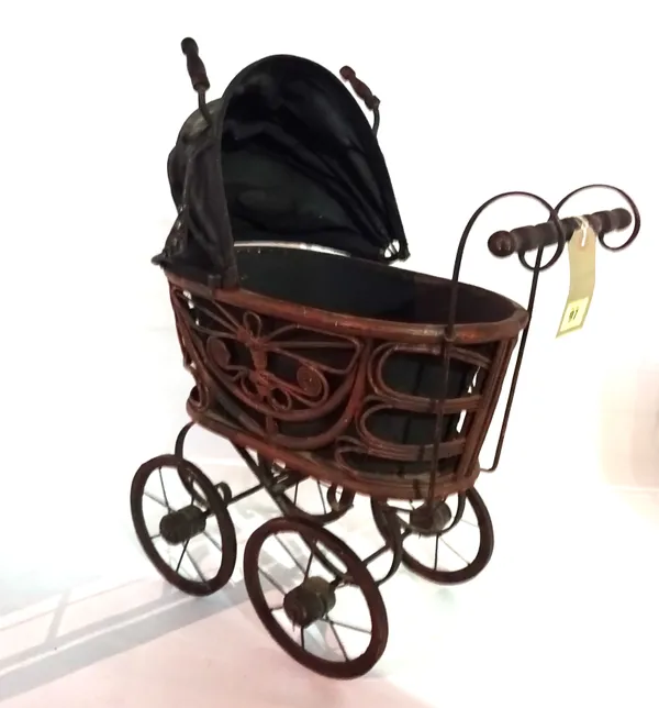 A 20th century stained pine and wrought iron miniature doll's pram.  BAY 1