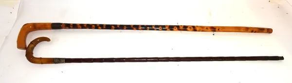 A bamboo and horn handled walking stick with silver mount together with another similar.   CAB