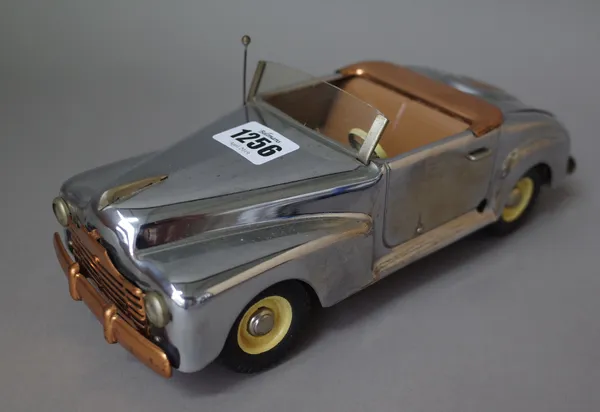 An Italian Marchesini American 'spider' convertible tinplate/clockwork car, mid-20th century, with mechanical Swiss music box in boot, chrome/copper l