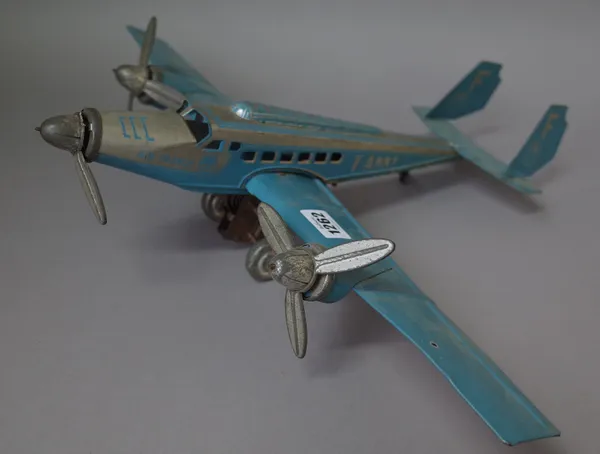 A French Joustra tinplate passenger aeroplane, circa 1936, detailed F-ANNY against a two tone blue and silver body, (a.f.) 52cm wide.