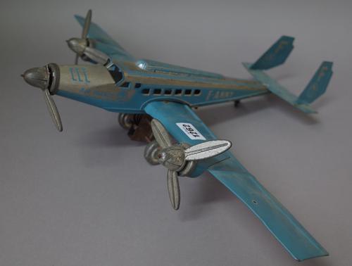 A French Joustra tinplate passenger aeroplane, circa 1936, detailed F-ANNY against a two tone blue and silver body, (a.f.) 52cm wide.