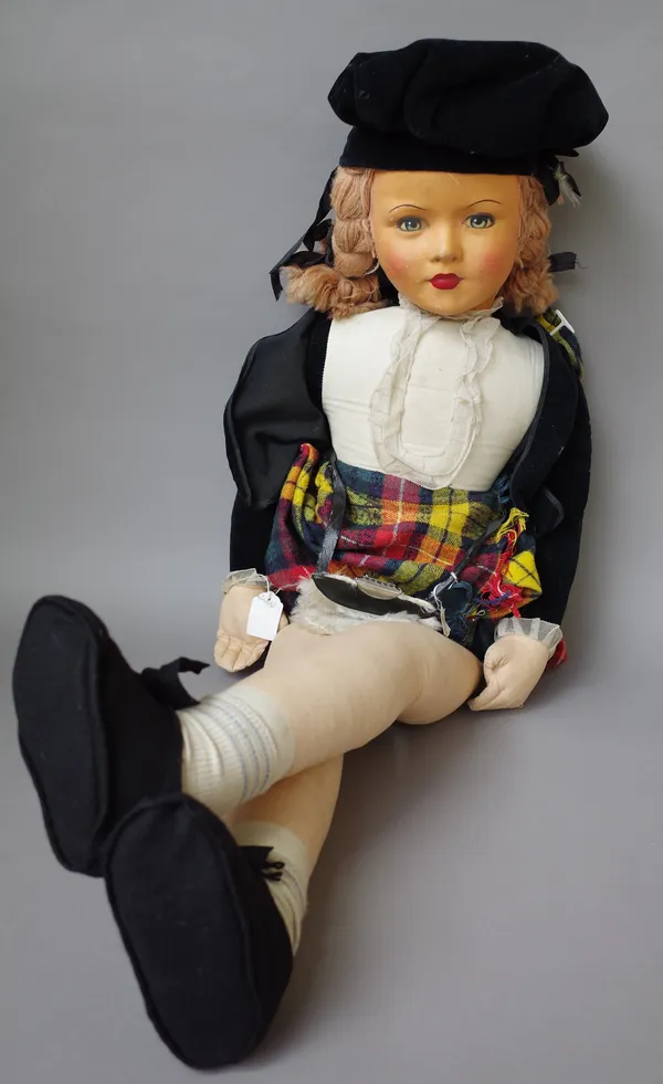 A Lenci style doll of large proportions, mid 20th century, with a painted linen face and stuffed body dressed in kilt and accessories, 104cm high.