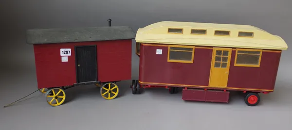 A wooden scale model shepherds hut, with lift-off domed roof and metal spoked wheels (34cm wide) and a circus type caravan, maroon and cream livery, (