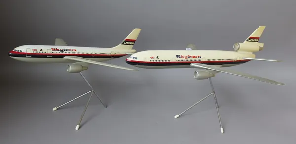 Laker Airways 'Skytrain' desktop model aeroplane, composition plastic on a metal stand, (wing span 49.5cm) and another matching smaller  'Skytrain' mo