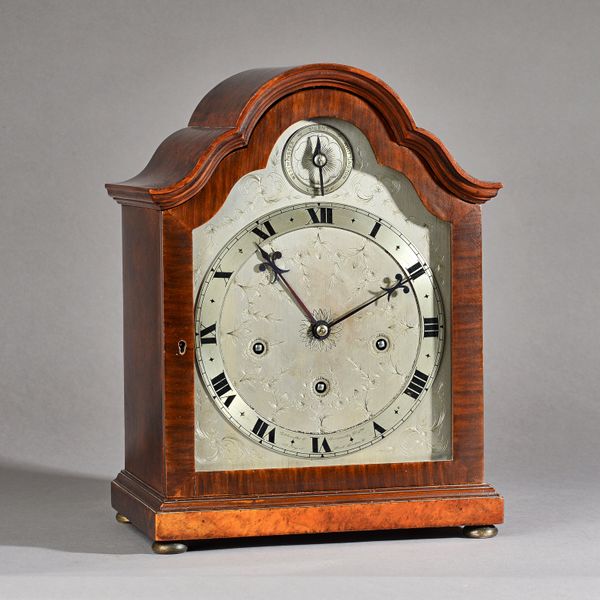 A burr walnut cased eight day mantel clock by Goldsmiths & Silversmiths Co Ltd, London, with engraved silvered dial and quarters, striking Westminster