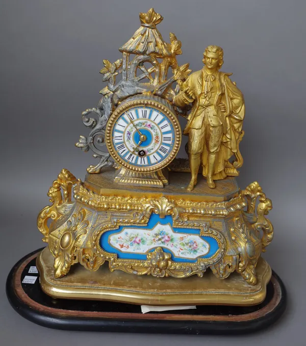 A late 19th century French gilt spelter eight day mantel clock, figural surmount above Sevres style dial and arched panel, drum movement striking on a