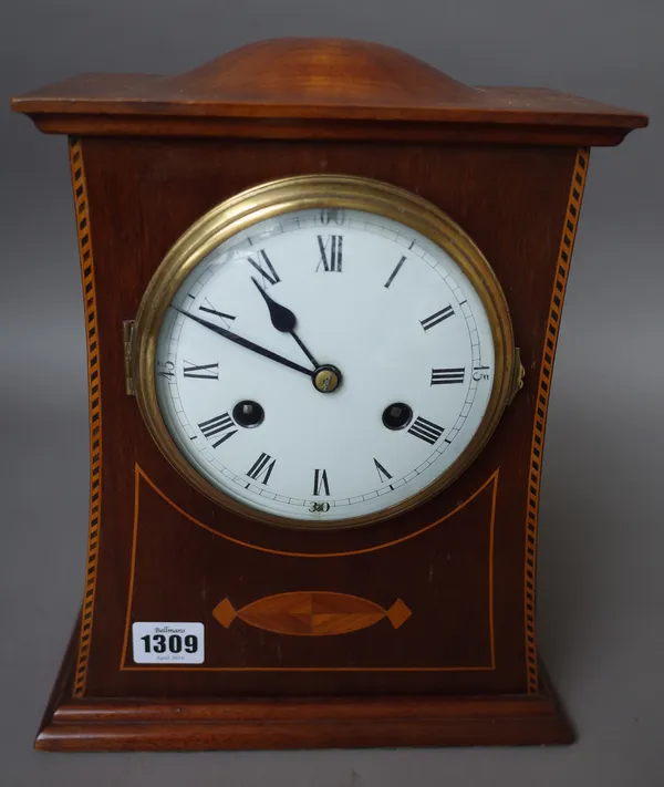 An Edwardian mahogany and inlaid mantel clock with domed top, five inch enamel dial and a two train movement, 30cm high, (key and pendulum).