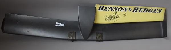 A carbon fibre nose cone from an F1 racing car, probably Jordan yellow livery with 'Benson & Hedges' advertising and indistinct signature possibly Mar