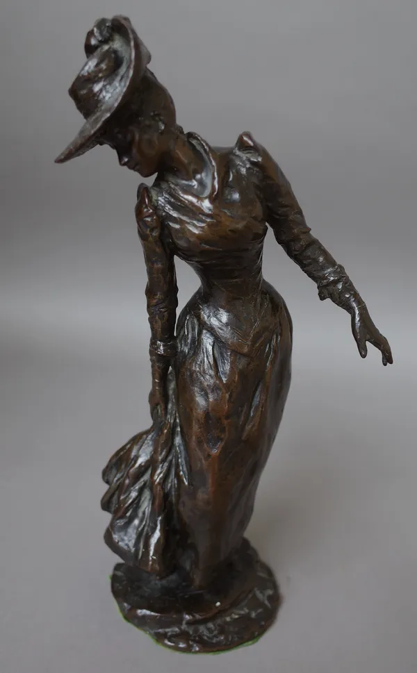 A bronze figure of a Victorian lady, indistinctly signed and dated 1892, modelled in a hat and long dress on a naturalistic base, 35cm high.