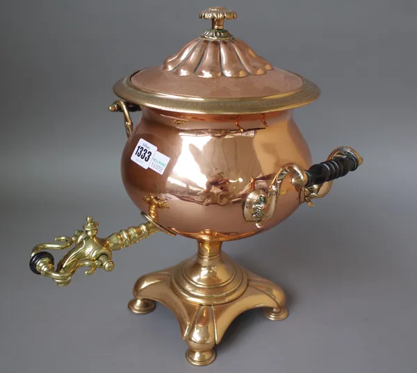 A Victorian copper and brass mounted samovar of circular form, with twin handles on a shaped base and four feet, 34cm high.