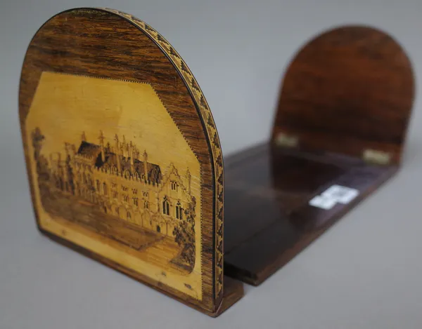 A Tunbridge ware sliding bookend, late 19th century, rosewood and marquetry inlaid, one end with a castle, the other with a priory, 33cm wide.