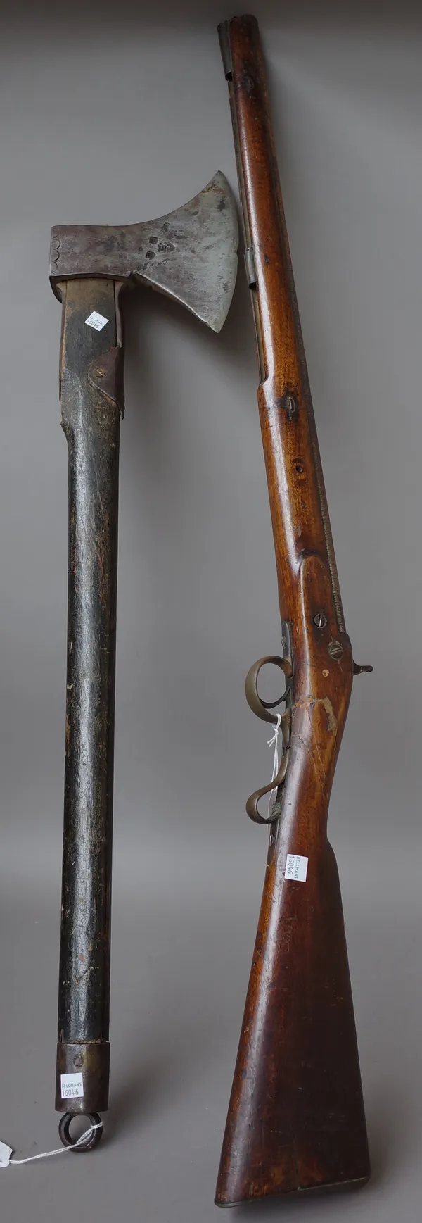 An unusual early 19th century steel axe with stamped marks to the blade with an ebonised shaft and steel lanyard ring, 92cm, and a 19th century percus