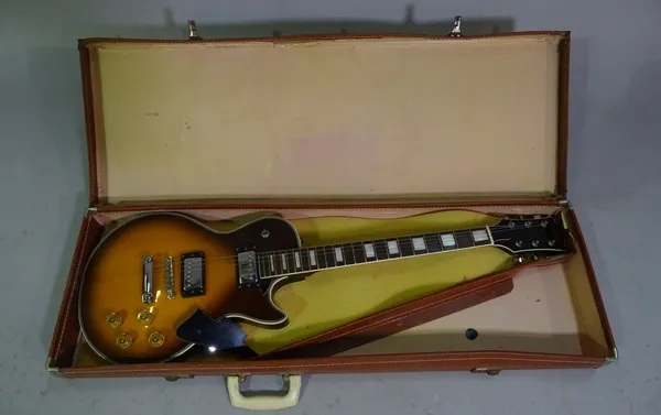 A Satellite Electric guitar in the style of a Gibson within a case.