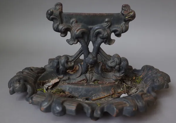 A Victorian cast iron boot scraper of foliate oval form, 35cm wide, a Victorian cast iron 'Lion' door stop with loop handle, 29cm high and a pair of 1