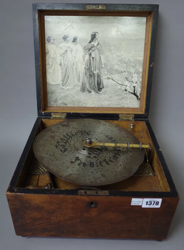 A German 'Kalliope' musical disc player, late 19th century, mahogany cased with a small collection of 9 inch discs. (a.f.)