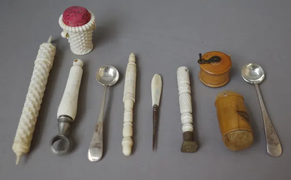 A quantity of small early 20th century sewing collectables including; a carved ivory 'basket' pin cushion, 4cm high, a Mauchline ware double ended pin