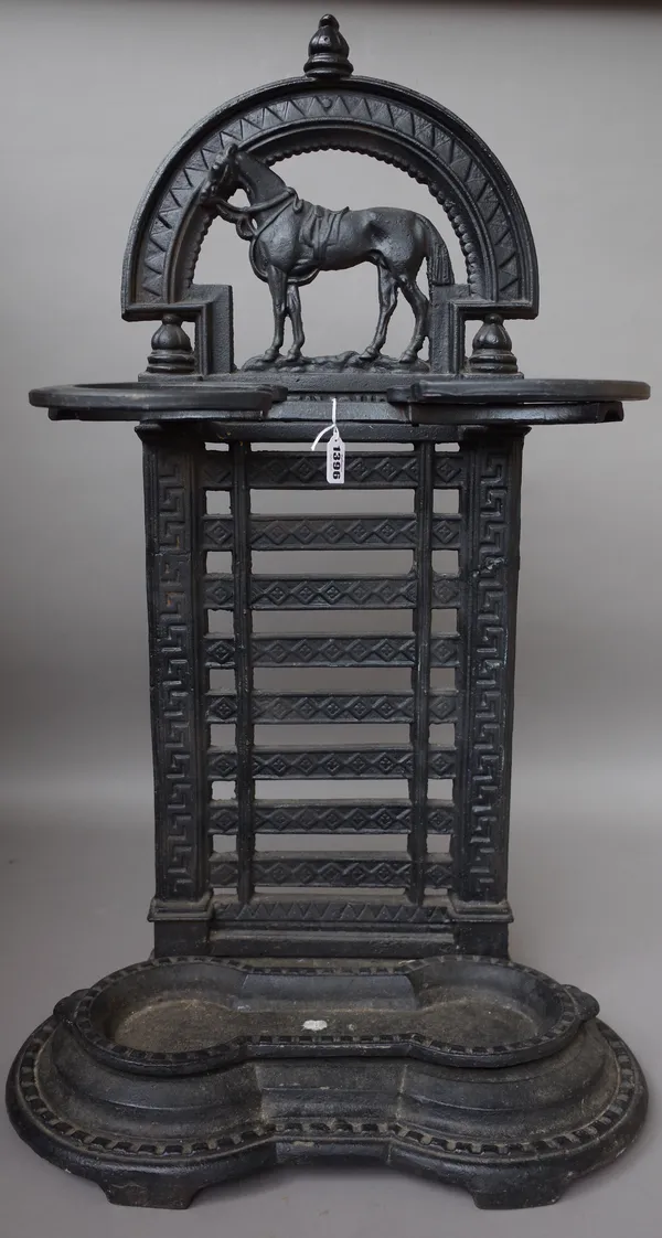 A cast iron stick stand, circa 1900, 'The Favourite', with horse surmount over title and horseshoe guards, with a ladder back and removable drip pan,