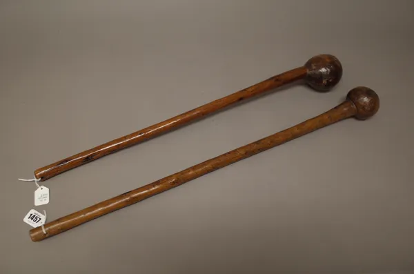 Two East African hardwood clubs, each with bulbous head and tapering cylindrical handle, the longest 70cm, (2).