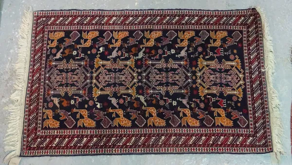 A Beluchistan rug, the black field with four central motifs, supported by pairs of birds, a banded leaf border, 158cm x 100cm.