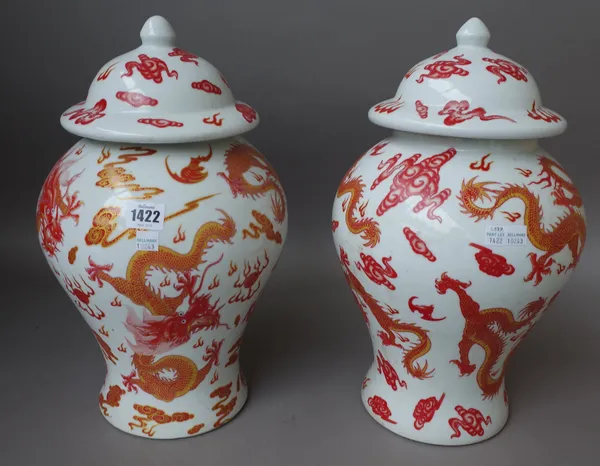 A pair of modern Chinese baluster vases and covers, each decorated with gilt red dragon against a white ground, blue printed mark to base, 40cm high,