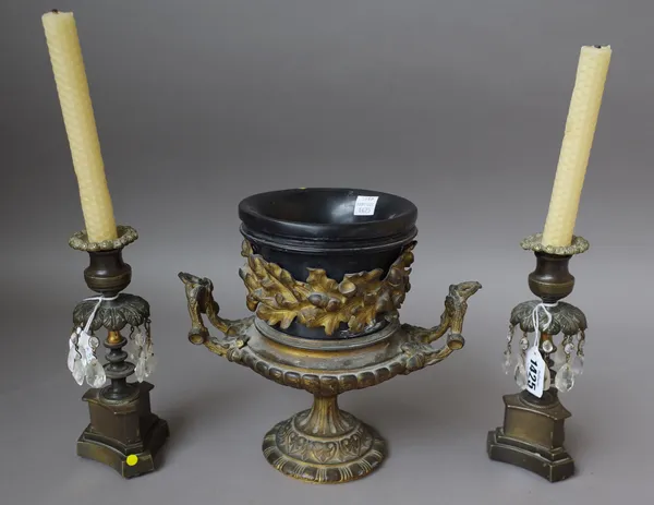 A pair of early 19th century lustre candlesticks on triform bases, 18.5cm high and a 19th century gilt bronze twin handled urn with oak leaf banding a