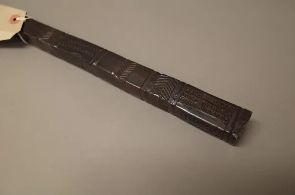 A South Sea Islands hardwood long stick or staff, with geometric carved decoration to the square form head (158cm) and a South Sea Islands spear (238c