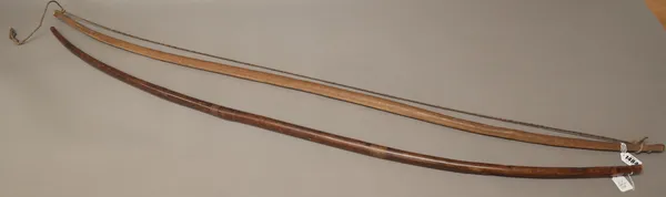 Two African wooden bows, one with leather binding, the longest 146cm (2).