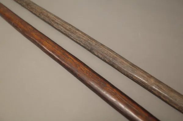 Two New Guinea wooden bows, one with leather bound terminal, (184cm), (2).