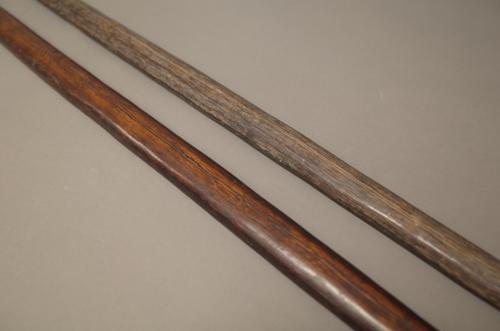 Two New Guinea wooden bows, one with leather bound terminal, (184cm), (2).