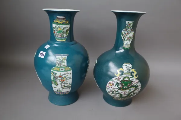 Two modern Chinese green ground vases each decorated with panels of famille verte vases, 37cm high and another similarly decorated blue ground vase, 4