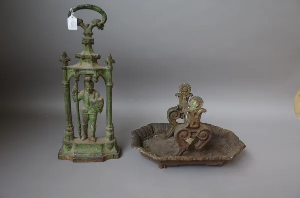 A Victorian cast iron boot scraper by Kenrick & Sons, 36cm wide and a Victorian half block figural door stop with loop handle and green painted decora