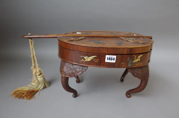 A Japanese hardwood inlaid box and cover of shaped stylised fan form, 20th century, decorated all over with flora & fauna and raised on four shaped le