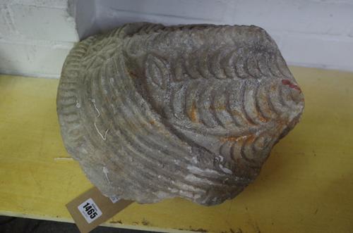 A partial stone carved mask, 34cm high and one further composite plaster wall plaque moulded in relief with an Aztec type mask, 57cm high, (2).