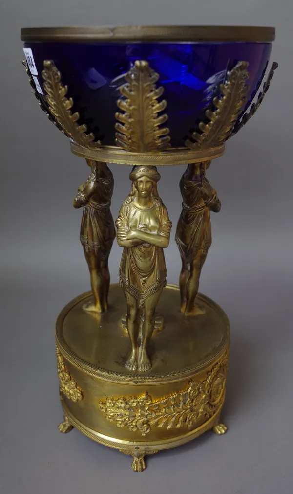 A French ormolu and blue flashed cut glass centrepiece bowl of Empire style late 19th / early 20th century, the bowl supported over three female figur