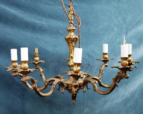 A French, 19th century style eight branch gilt bronze chandelier, the baluster stem issuing eight foliate scroll branches, 50cm high.