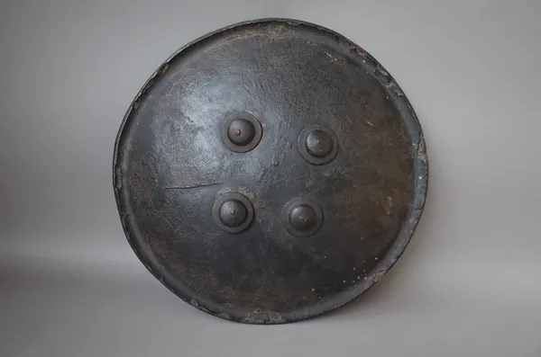 An Indo-Persian Dhal (shield), made of animal hide with four central metal bosses, 51cm diameter.