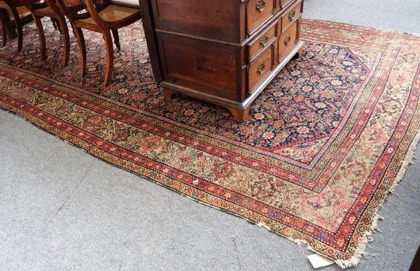 A Kashan carpet, early/mid-20th century, brick red main field with stepped white and blue central medallion, similar spandrels, repeating floral main