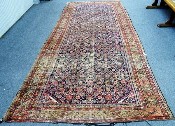 A Fereghan kelleh carpet with all-over Herati design,  on a midnight blue ground with multiple borders, approximately 478cm x 229cm.