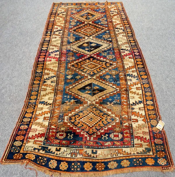 An Antique Kazak short runner, with ivory wine cup and leaf main border approximately 312cm x 135cm and a modern Kurdish runner with burnt orange main