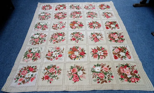 A needlework tapestry, made up of six rows of fine squares, each bearing floral bouquets, 295cm x 244cm.