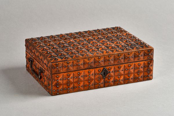 An early 19th century French  fruitwood iron stud mounted rectangular box, with facet cut decoration, 28cm wide x 9cm high. Illustrated.