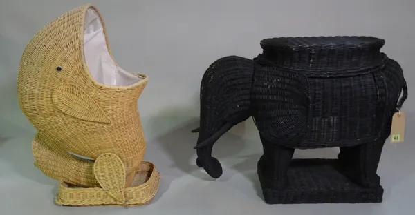 A 20th century black painted wicker figure of an elephant, 70cm wide x 58cm high, and a wicker laundry basket in the form of a whale, 70cm high, (2).